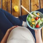 Kobieta w ciąży trzymająca miskę sałatki – zdrowa dieta i BMI w ciąży